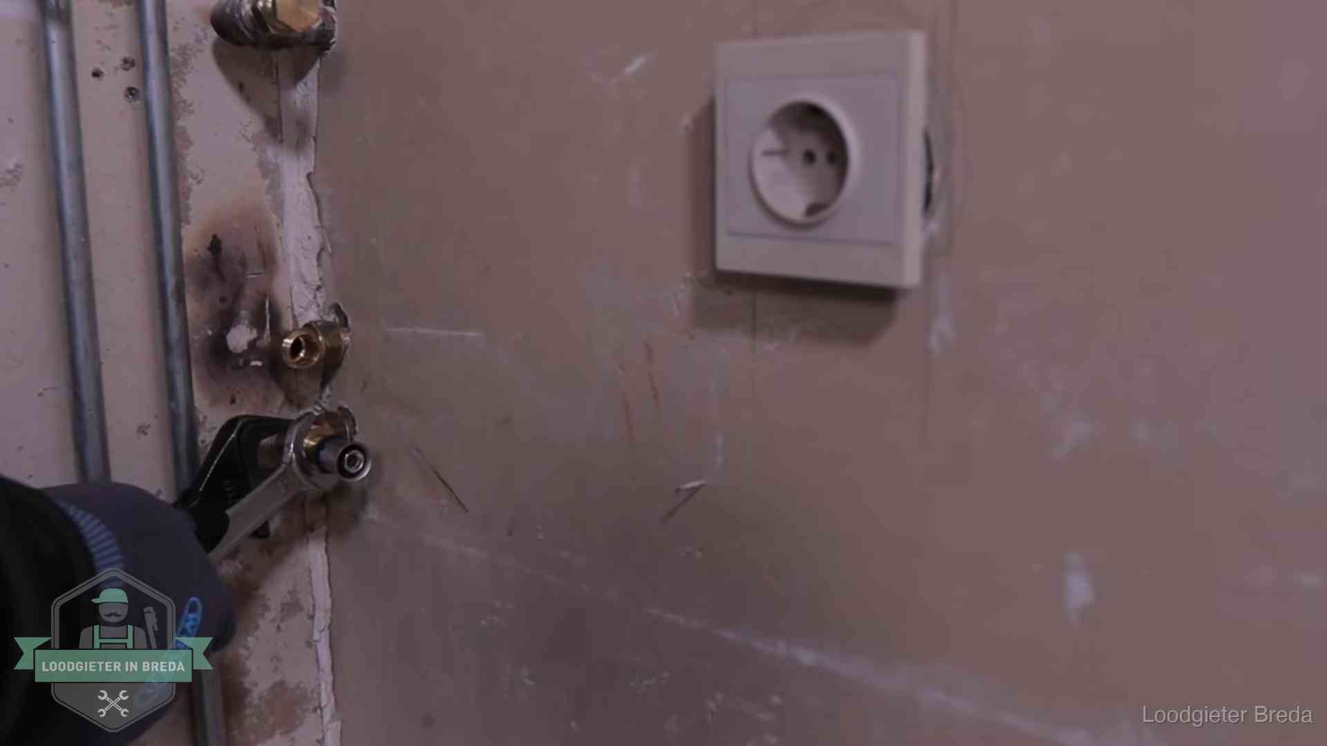 Erkend vakmanschap in Breda Monteur draait een perskoppeling vast op een leidingaansluiting in Breda